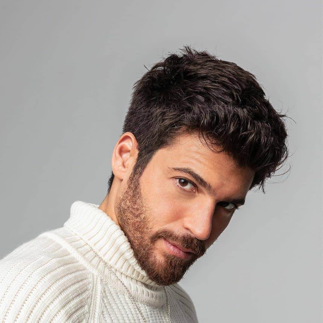 Can Yaman in a white sweater